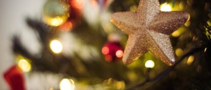 Star Christmas ornament hanging on a tree