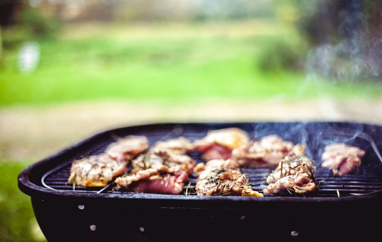 Chicken cooking on a barbeque outside