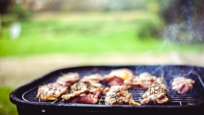 Chicken cooking on a barbeque outside